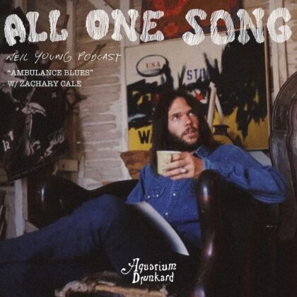 Podcast cover for All One Song: Ambulance Blues. Man with long hair in a denim shirt holds a mug in a room with posters; Aquarium Drunkard.