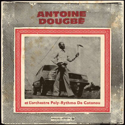 Album cover featuring a man with a curved blade standing beside a car, framed by a red patterned border and bold red typography at the top and bottom.
